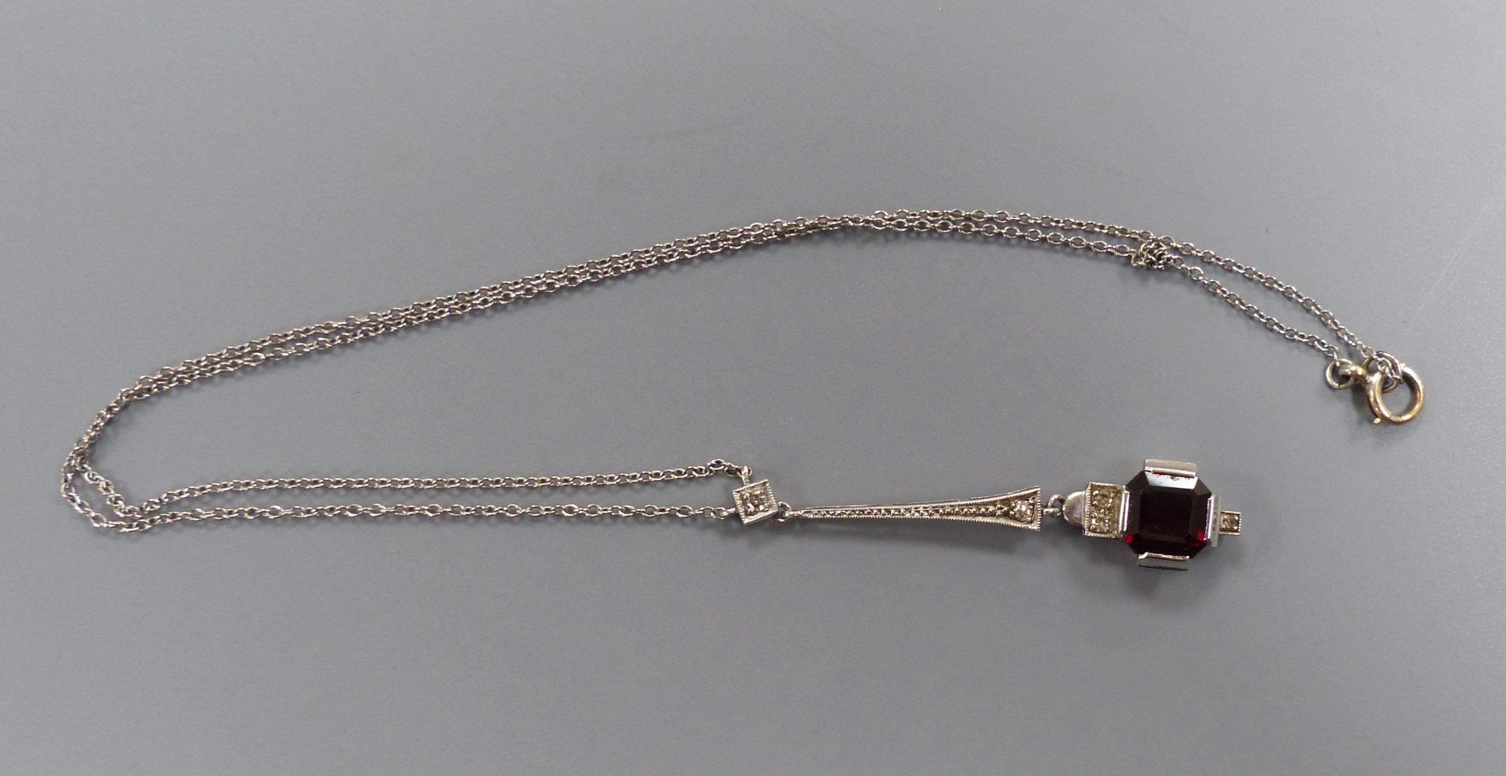 A 1920's white metal, hessonite garnet and diamond set drop pendant necklace, pendant 44mm,
